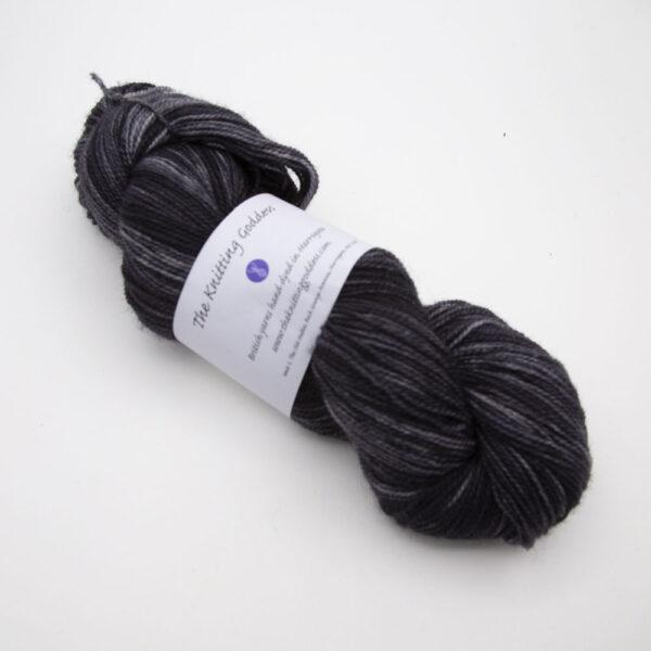 black hand dyed sock yarn, wound up in a skein, The Knitting Goddess ball band