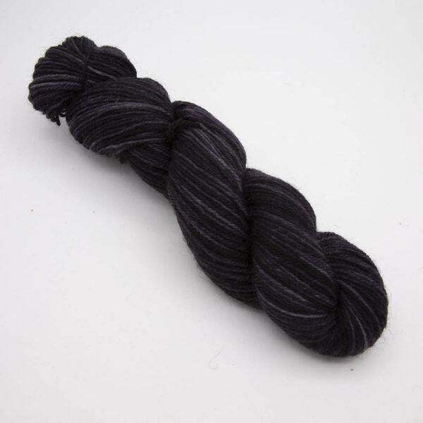 black hand dyed sock yarn, wound up in a skein