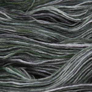 close up of hand dyed bluefaced leicester wool in blackened forest, a warm olive green overdyed with black