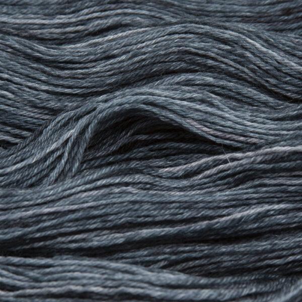 close up of hand dyed bluefaced leicester wool in blackened green, a cool green overdyed with black