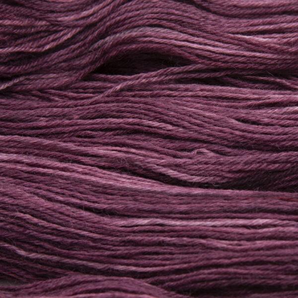 close up of hand dyed bluefaced leicester wool in blackened red, a warm red overdyed with black