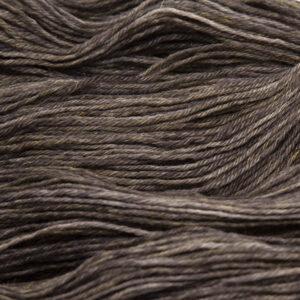 close up of blackened walnut Bluefaced Leicester wool, warm brown overdyed with black