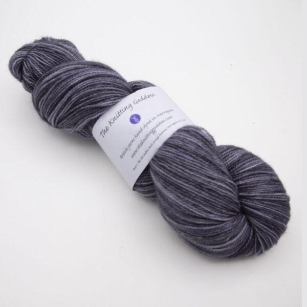 charcoal hand dyed sock yarn, wound up in a skein, The Knitting Goddess ball band