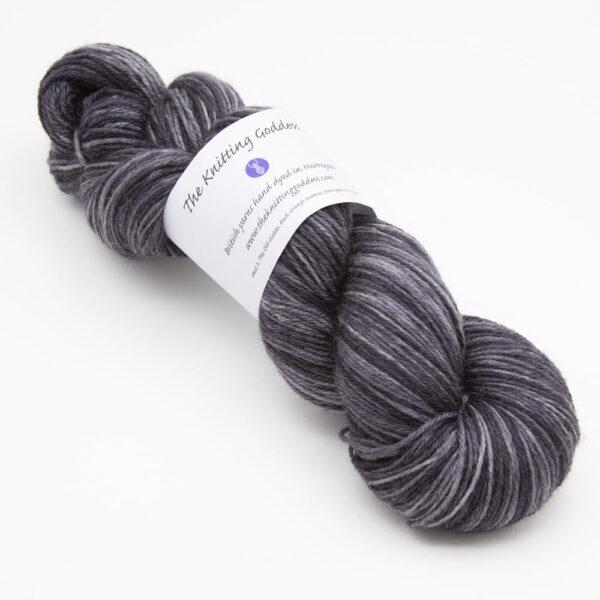 skein of charcoal Bluefaced Leicester wool, The Knitting Goddess ball band
