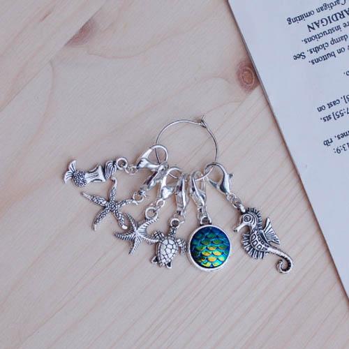 set of stitch markers with hook fastenngs, including a mermaid design