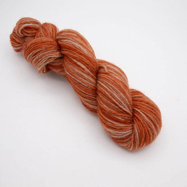 copper hand dyed sock yarn, wound up in a skein