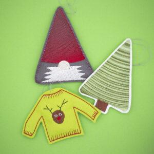 three embroidered christmas tree decorations, gnome with red hat and white bears, tree with mixed greens and lime green christmas jumper with cartoon reindeer