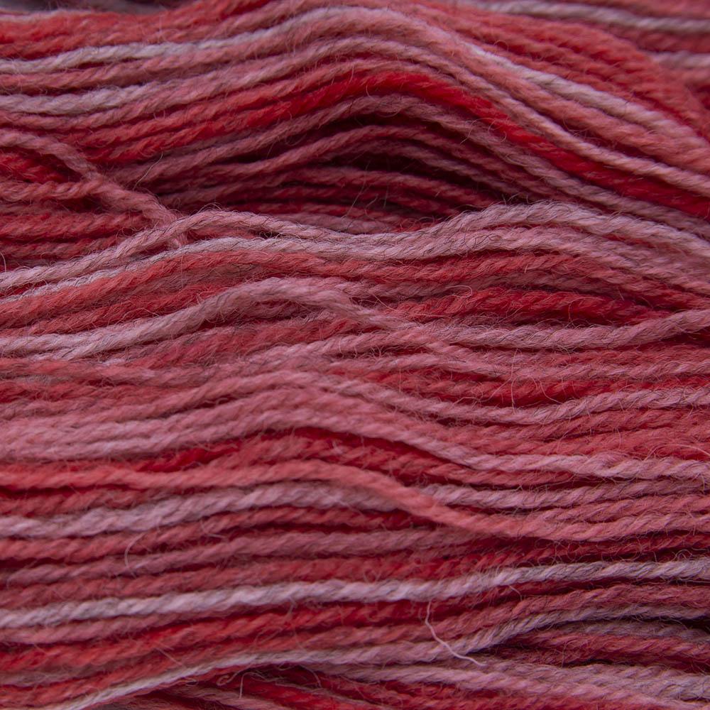 geranium (red with a touch of orange) hand dyed sock yarn, close up showing tonal variations