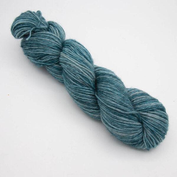 green hand dyed sock yarn, wound up in a skein