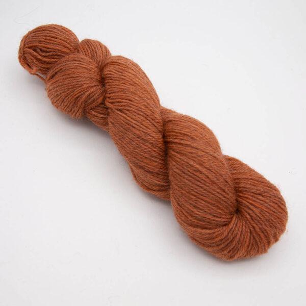 orange hand dyed sock yarn, wound up in a skein