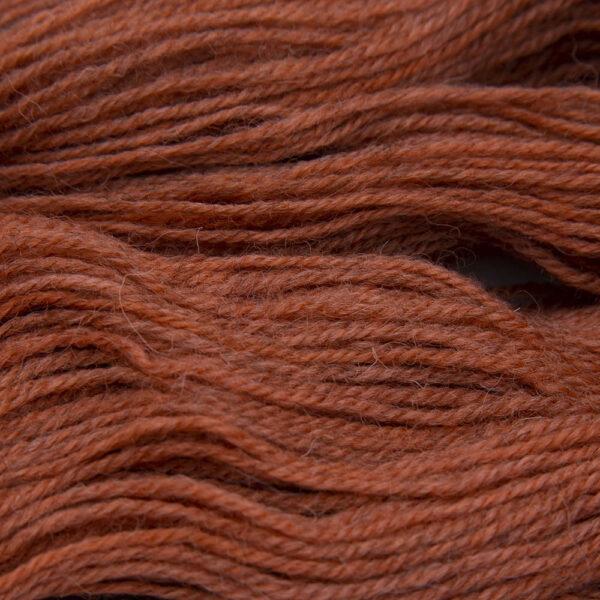 orange hand dyed sock yarn, close up showing tonal variations