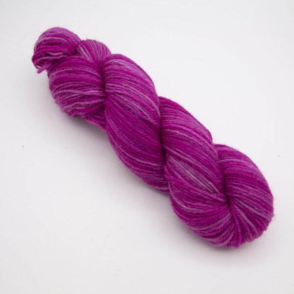 raspberry hand dyed sock yarn, wound up in a skein