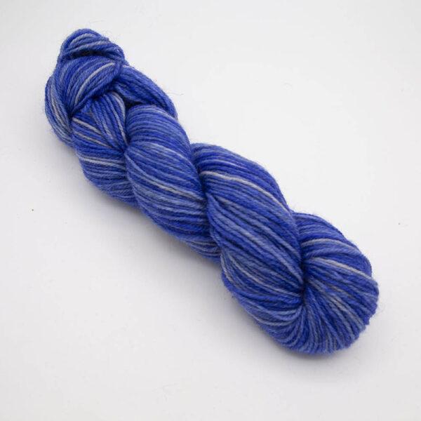 violet hand dyed sock yarn, wound up in a skein