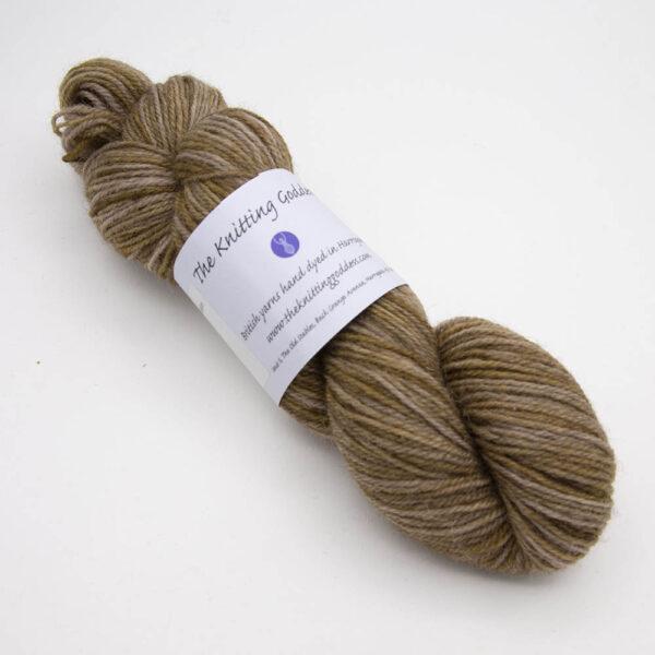 walnut hand dyed sock yarn, wound up in a skein with The Knitting Goddess ball band