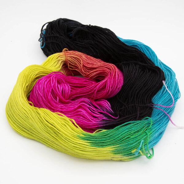 open skein of neon black showing black, pink, yellow and turquoise