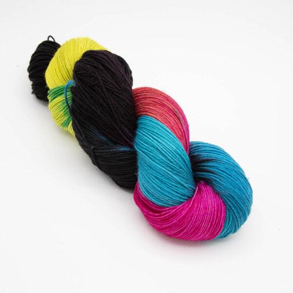 skein of neon black twisted up. The skein has not been rewound so the colours show as blocks.