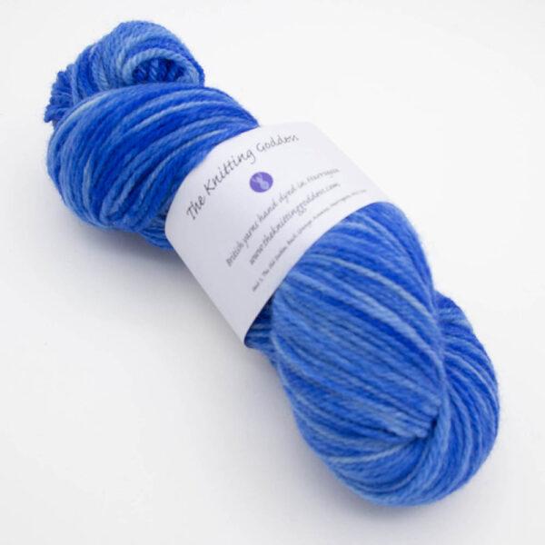skein of blue DK sock wool with The Knitting Goddess ball band