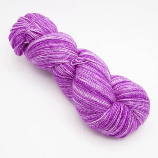 skein of bright pink Bluefaced Leicester and nylon yarn which has a high twist