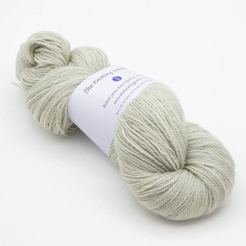 Candy is Dandy semi solid yarn , pale grey with a lint of lime green. The skein has The Knitting Goddess ball band.
