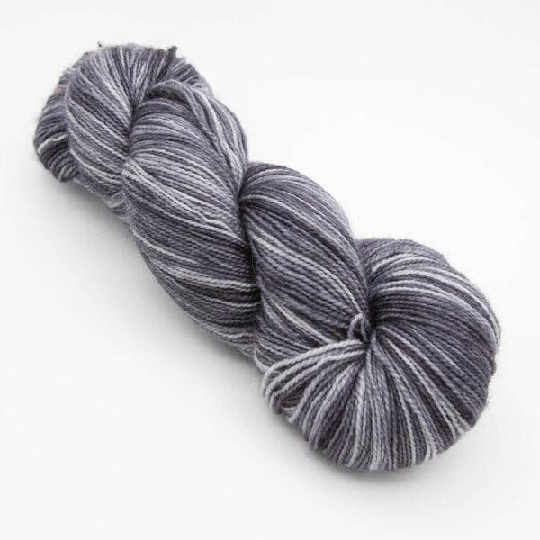 skein of charcoal grey Bluefaced Leicester and nylon yarn which has a high twist