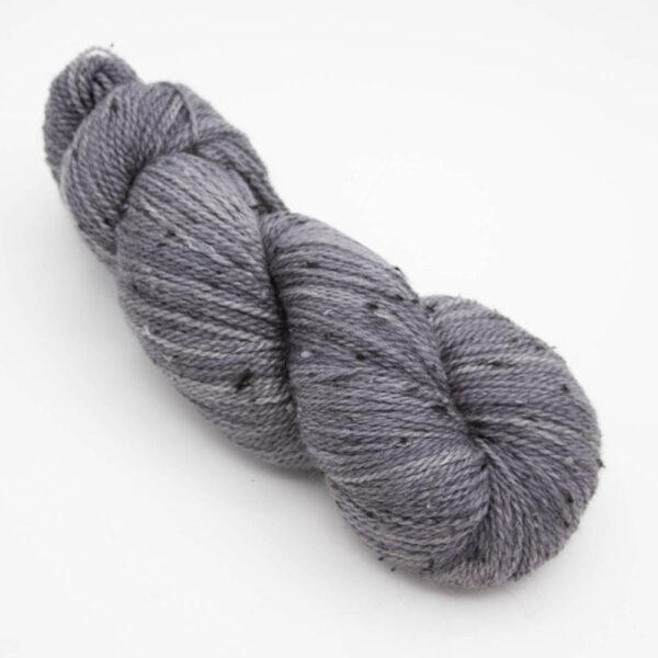 skein of charcoal grey coal tweed yarn with dark flecks