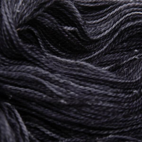 close up of very dark grey coal tweed yarn with dark flecks