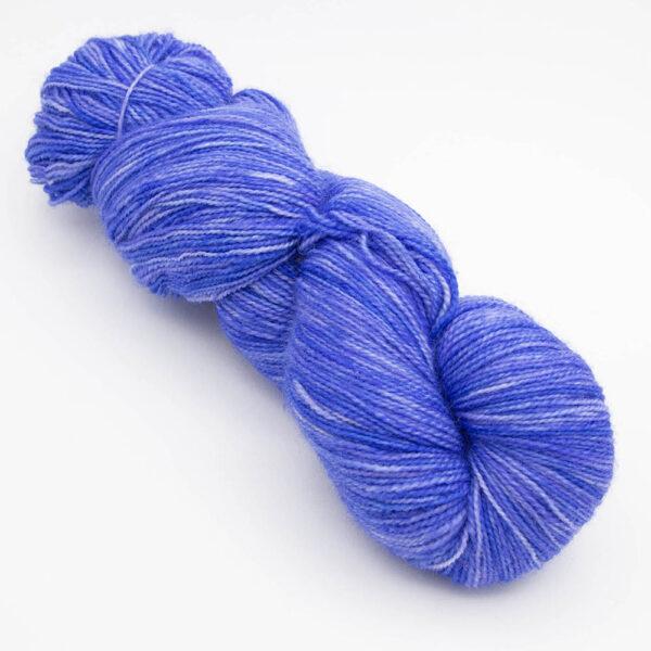 skein of cornflower blue ( blue with a little purple) Bluefaced Leicester and nylon yarn which has a high twist