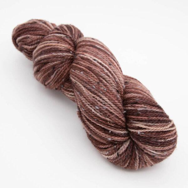 skein of dark copper tweed yarn with dark flecks