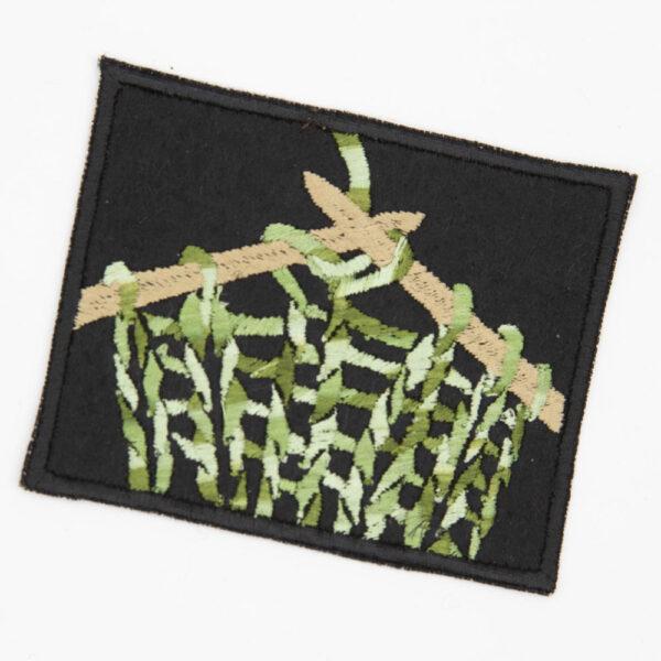 embroidered patch of knitting in green yarn