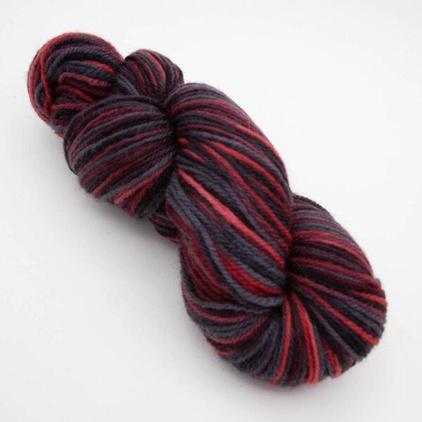 skein of menace DK sock wool dyed with red and black