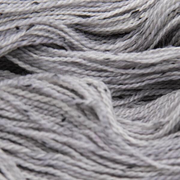close up of pale grey pearl tweed yarn with dark flecks