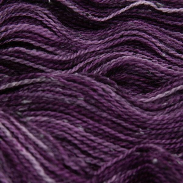 close up of plum tweed yarn with dark flecks