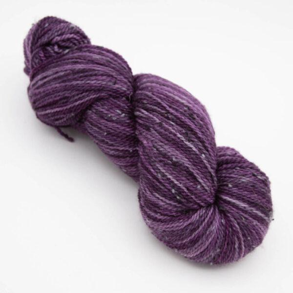 skein of plum tweed yarn with dark flecks