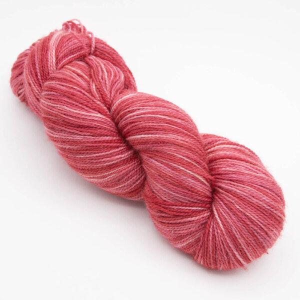 skein of red Bluefaced Leicester and nylon yarn which has a high twist