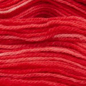 close up of red DK sock wool with The Knitting Goddess ball band