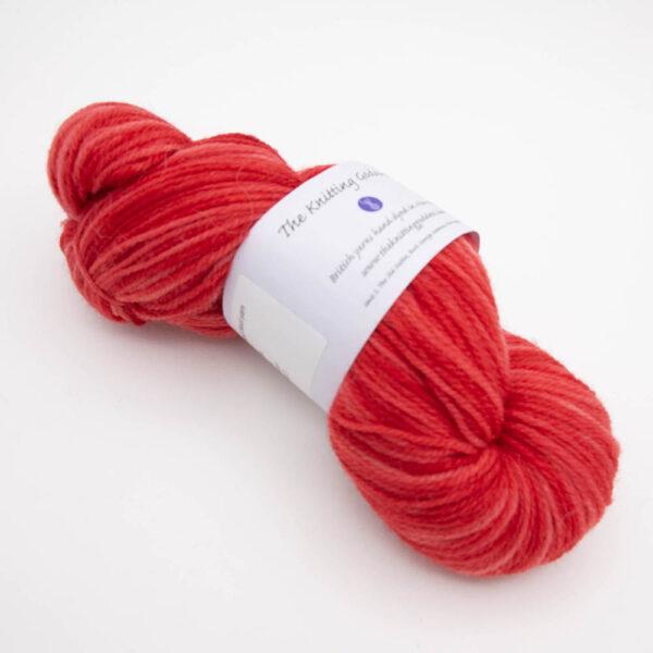 skein of red DK sock wool with The Knitting Goddess ball band