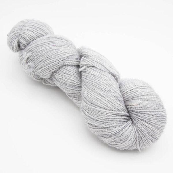 skein of silver grey Bluefaced Leicester and nylon yarn which has a high twist