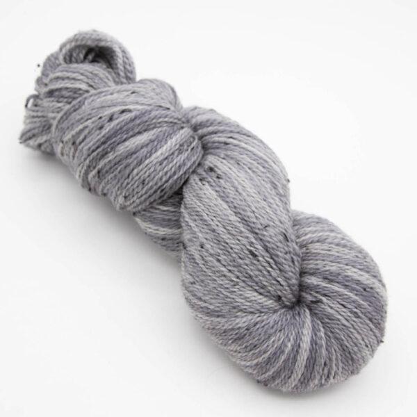 skein of silver tweed yarn with dark flecks