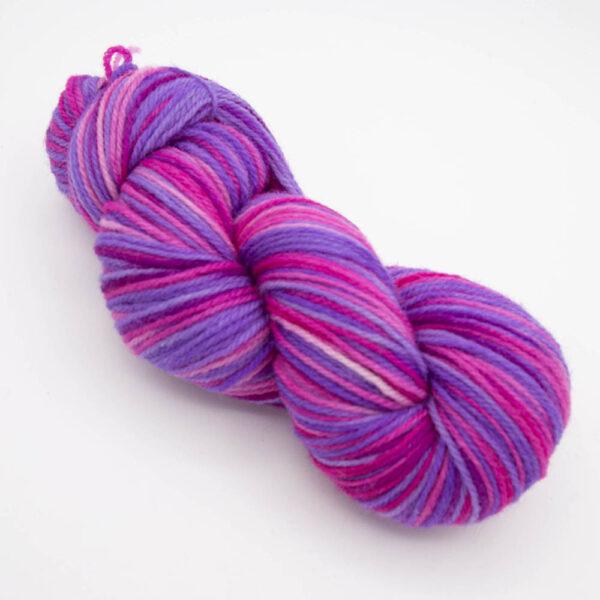 skein of sweet pea DK sock wool dyed in purple and pink
