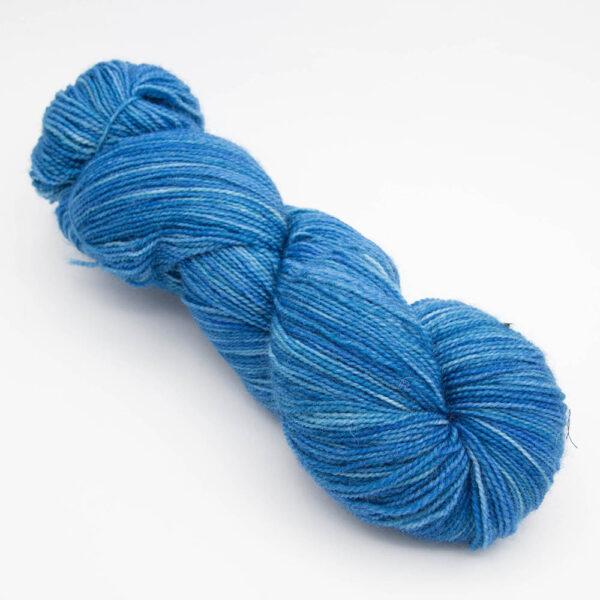 skein of teal blue Bluefaced Leicester and nylon yarn which has a high twist