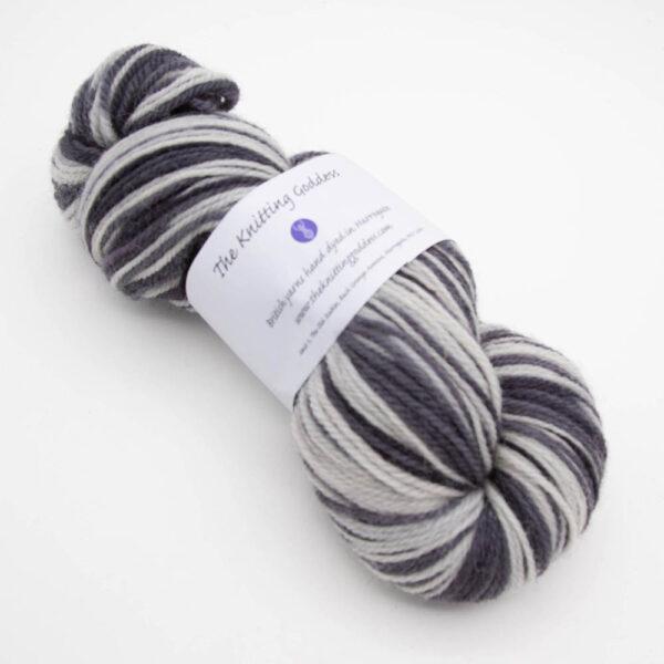 skein of thunder and lightening DK sock wool dyed in white and black with The Knitting Goddess ball band