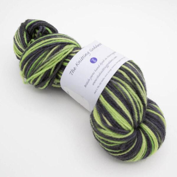 skein of toxic DK sock wool dyed in lime and black with The Knitting Goddess ball band