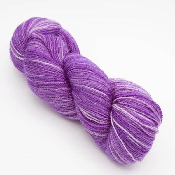skein of wisteria (pinkish purple) Bluefaced Leicester and nylon yarn which has a high twist