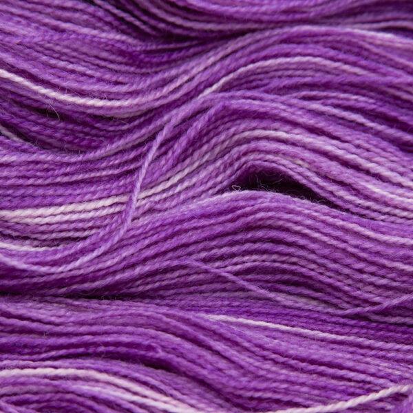 close up of wisteria (pinkish purple) Bluefaced Leicester and nylon yarn which has a high twist