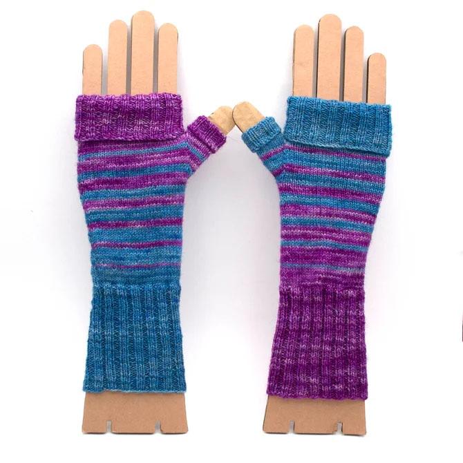 a pair of fingerless mitts with teal and wisteria pin stripes. One mitt is the mirror image of the other, so the stripe colours are reversed.