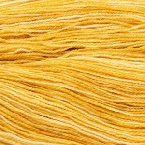 close up of hand dyed gold yarn