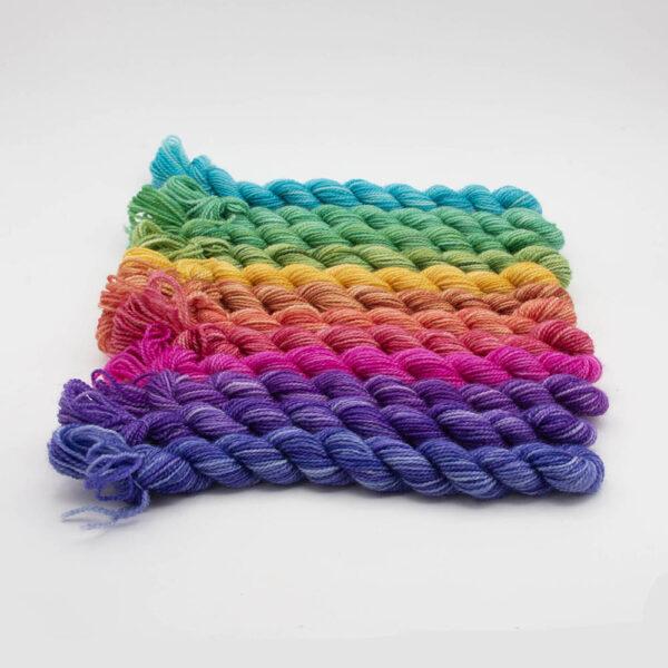 set of 12 mini skeins dyed in a hues colour wheel arranged in a row