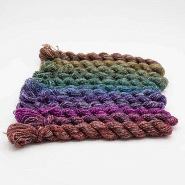 set of 12 mini skeins dyed in a shades colour wheel arranged in a row